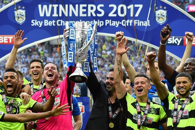 Huddersfield lift the trophy after beating Reading on penalties