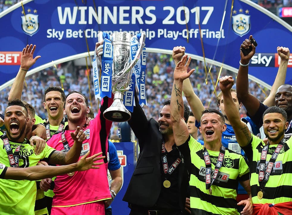 Huddersfield lift the trophy after beating Reading on penalties