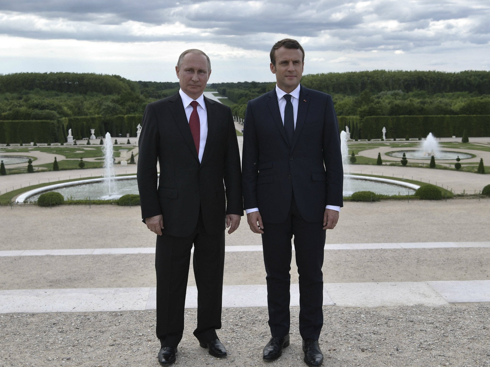 French President Emmanuel Macron, right, and Russian President Vladimir Putin in the gardens of the Chateau de Versailles