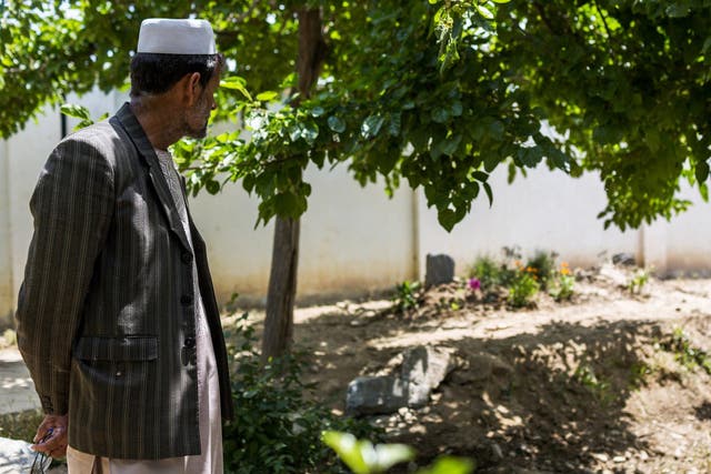An instructor at the seminary founded by Mawlawi Shah Agha Hanafi visiting his burial site on the school’s grounds in Parwan Province, Afghanistan