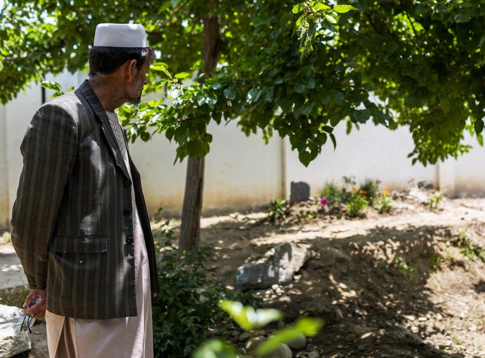 An instructor at the seminary founded by Mawlawi Shah Agha Hanafi visiting his burial site on the school’s grounds in Parwan Province, Afghanistan