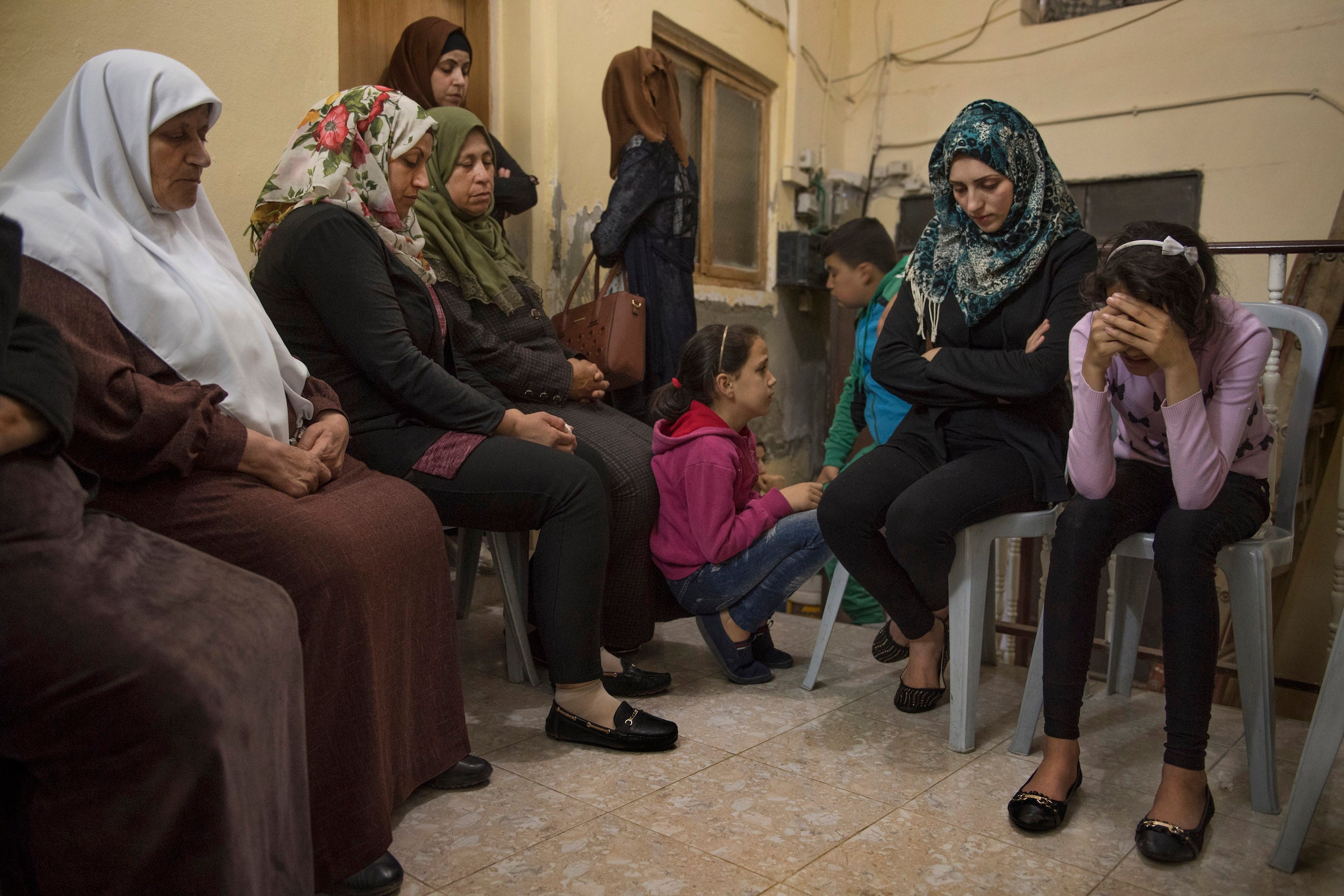 Among friends: Roa’a Abu Salah, 24, second from right, and Siwar Abu Salah, 13, mourn their mother in Arraba