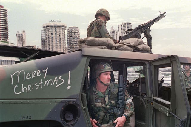 US soldiers man their security position outside the Vatican embassy in Panama City where Panamanian General Manuel Noriega sought asylum during Operation Just Cause, on December 25, 1989.