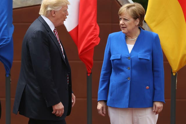 Donald Trump and German Chancellor Angela Merkel meet during the Group of Seven (G7) meeting in Taormina, Italy