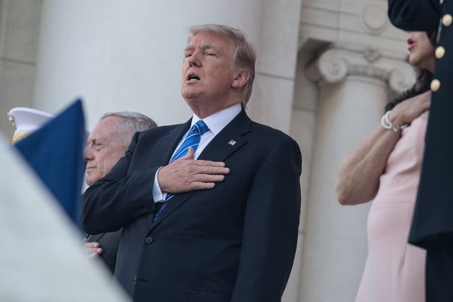 US President Donald Trump sings the national anthem before speaking at Arlington National Cemetery to mark Memorial Day in Arlington, Virginia