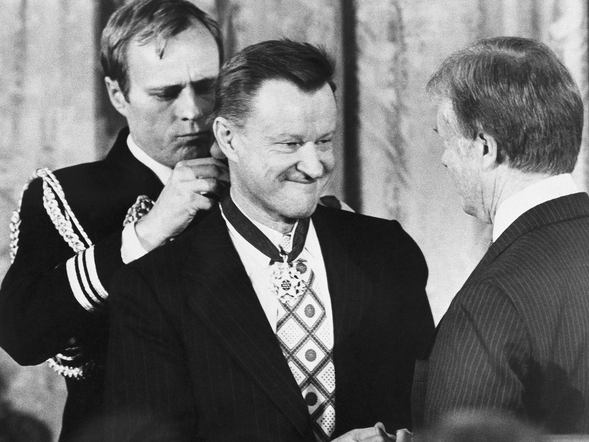 President Jimmy Carter presents Zbigniew Brzezinski with the Medal of Freedom at a White House ceremony in Washington in January 1981