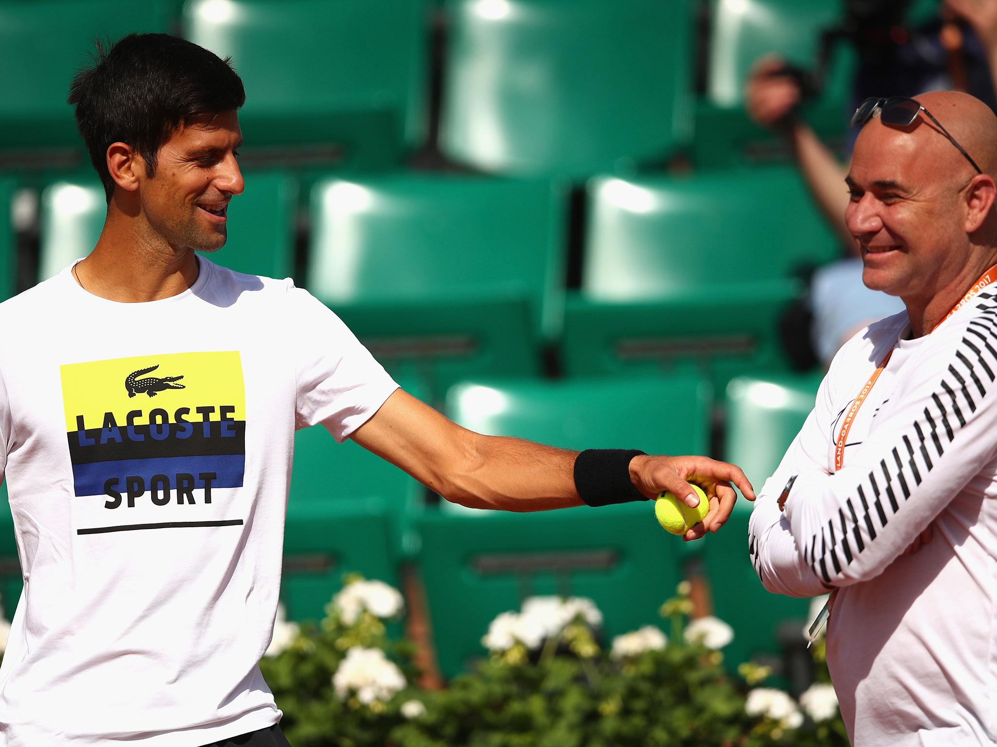 Novak Djokovic and Andre Agassi together during a training session
