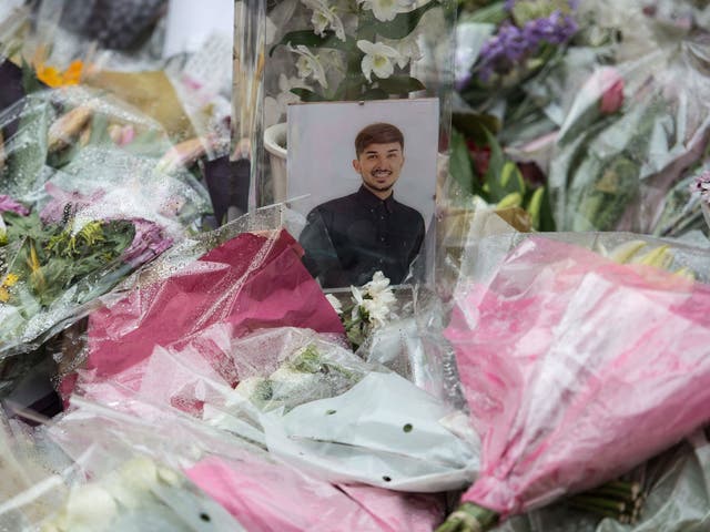 People gather to see flowers and messages of support in St Ann's Square in Manchester, northwest England on May 30, 2017, placed in tribute to the victims of the May 22 terror attack at the Manchester Arena