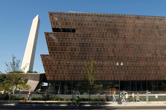 The Washington Monument rises behind the National Museum of African American History and Culture on the National Mall in Washington