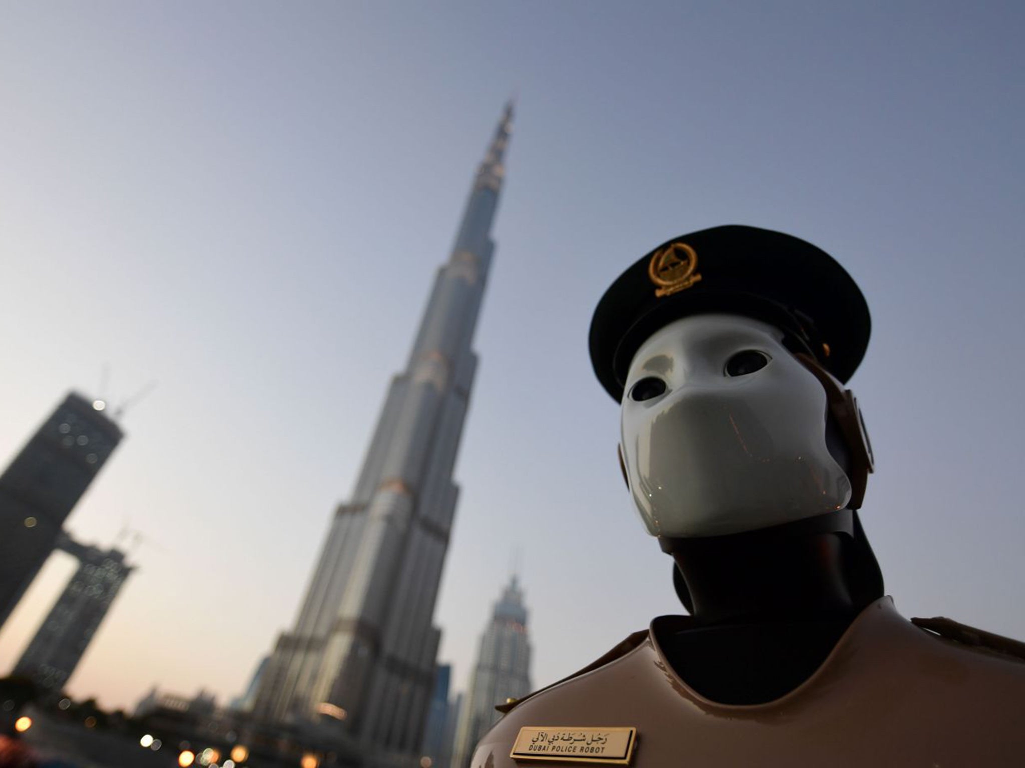 The world’s first operational police robot stands to attention near the Burj Khalifa in Dubai