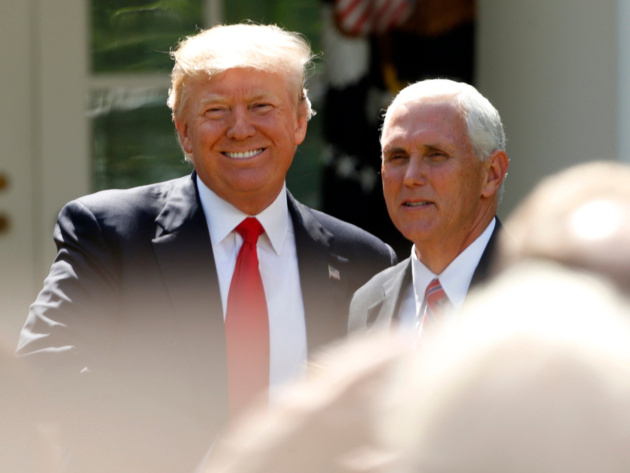 President Donald Trump arrives next to Vice President Mike Pence to announce his decision that the United States will withdraw from the landmark Paris climate agreement