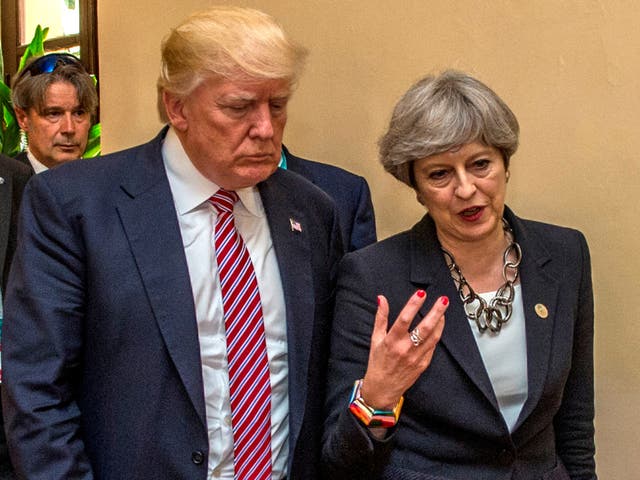 President Donald Trump walks with British Prime Minister Theresa May at the G7 summit in Taormina, Sicily