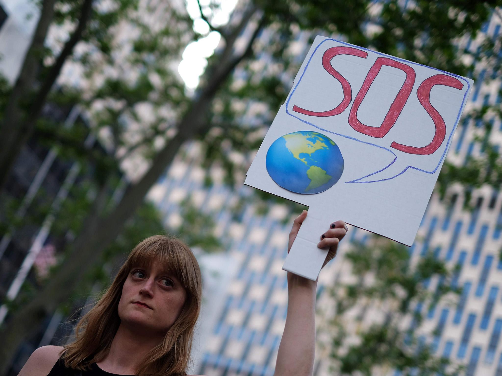 A woman displays a placard during a demonstration in New York on June 1, 2017