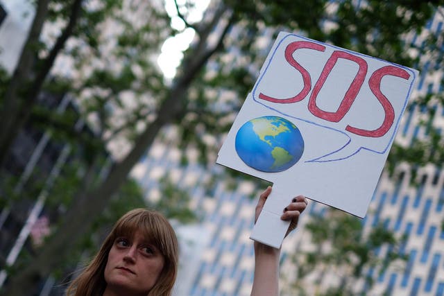A woman displays a placard during a demonstration in New York on June 1, 2017