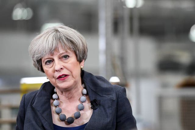Theresa May speaks to workers during a general-election campaign tour stop at Ultima Furniture Systems Ltd. in Pontefract
