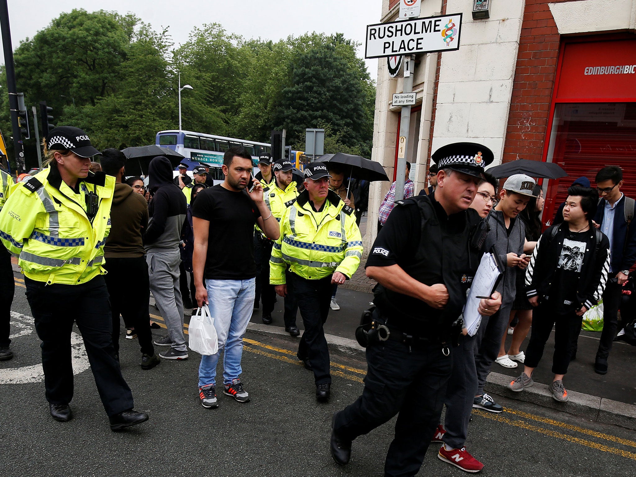 Police and evacuated students and residents at a cordon in Rusholme, Manchester, on 2 June Reuters