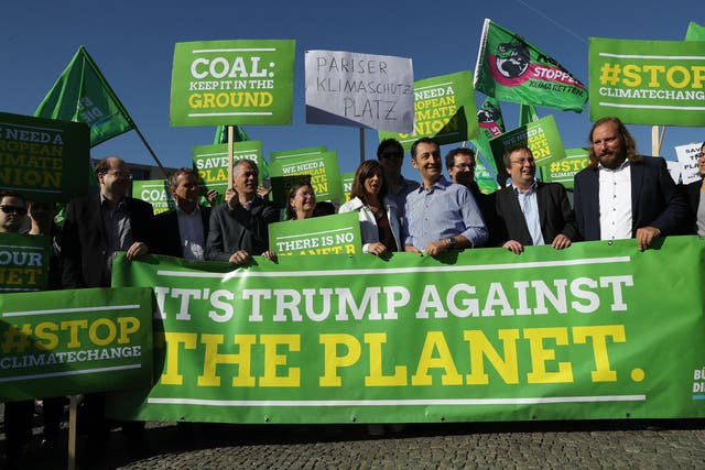 Members of the German Greens Party protest outside the US Embassy in Berlin against the announcement by Donald Trump that he will pull the US out of the Paris agreement
