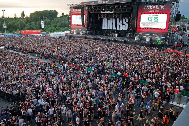 Festivalgoers leave the site of the 'Rock am Ring' festival at the Nuerburgring circuit after a terrorist threat warning
