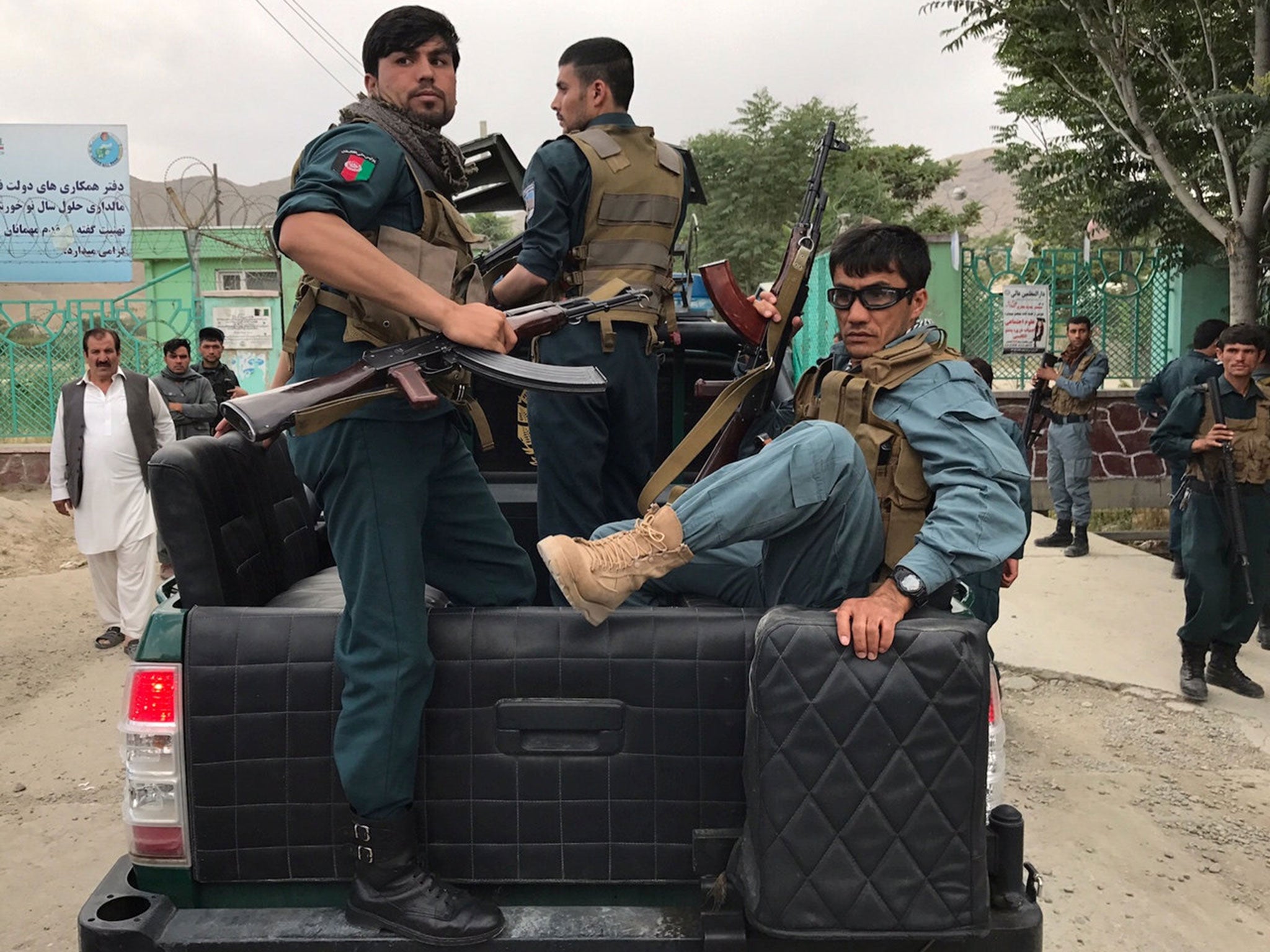 Afghan policemen arrive at the site of blasts in Kabul, Afghanistan