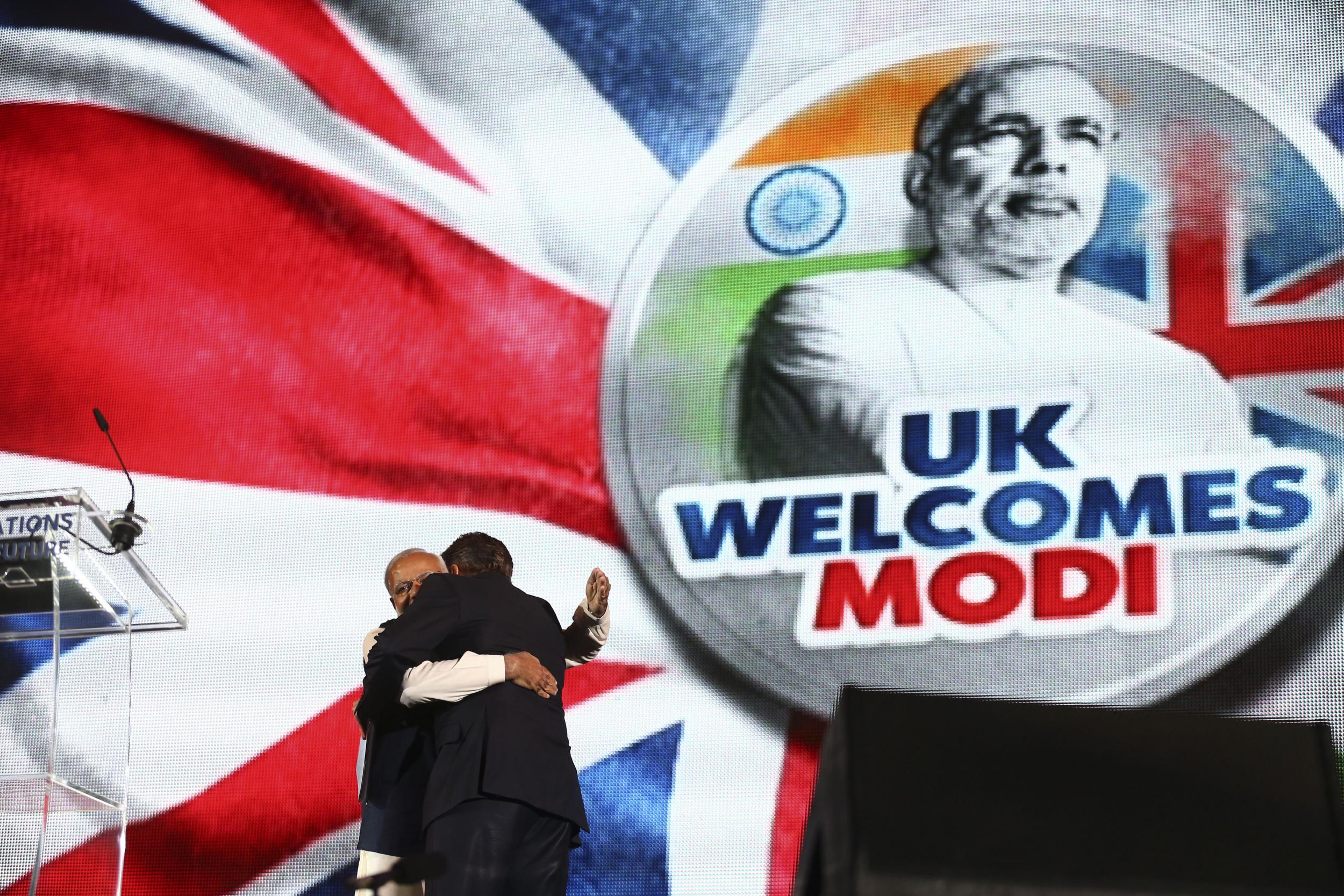 Narendra Modi embraces then British prime minister David Cameron on stage at Wembley Stadium in London on 13 November 2015