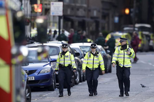 British police officers patrol a cordoned off area after an attack in the London Bridge