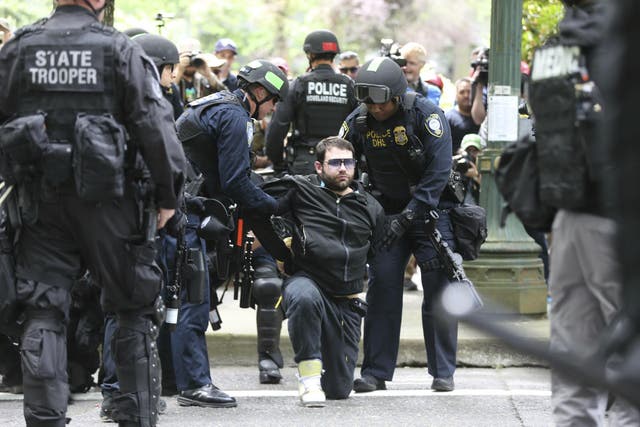 A protester is detained by Portland police during a demonstration in Portland