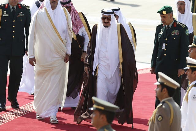  Saudi Arabia's King Salman (C) is seen walking with the Emir of Qatar, Tamim bin Hamad al-Thani (L) - BAE has sold both states high-tech equipment that could be used against Britain