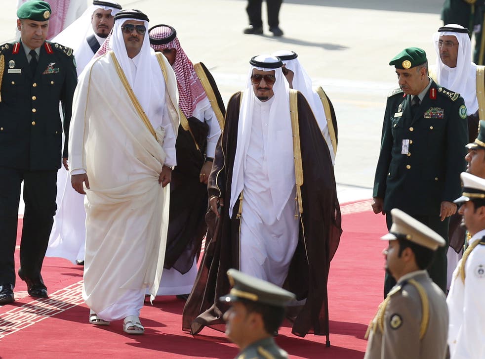 Saudi Arabia's King Salman (C) is seen walking with the Emir of Qatar, Tamim bin Hamad al-Thani (L) - BAE has sold both states high-tech equipment that could be used against Britain