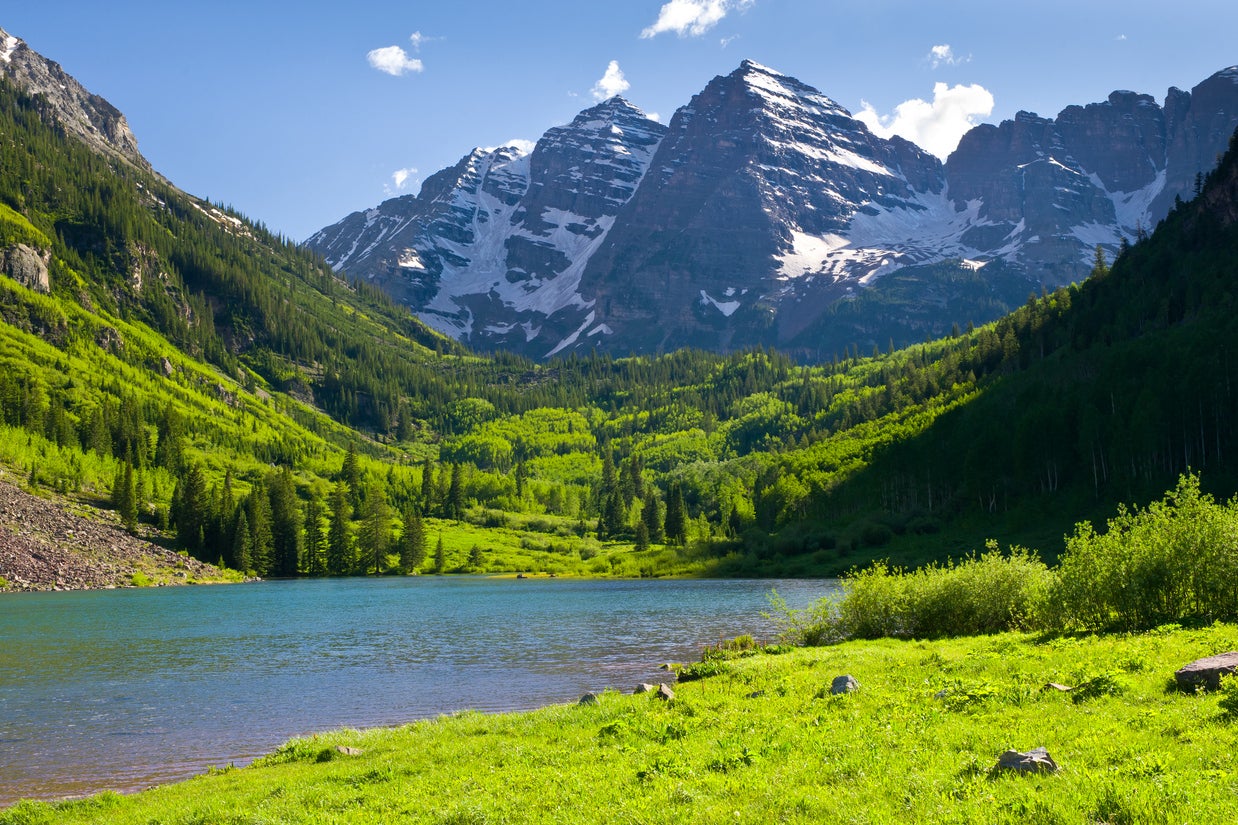 Maroon Bells features several hiking trails and a lake, which a family were seen paddling in despite it being roped off