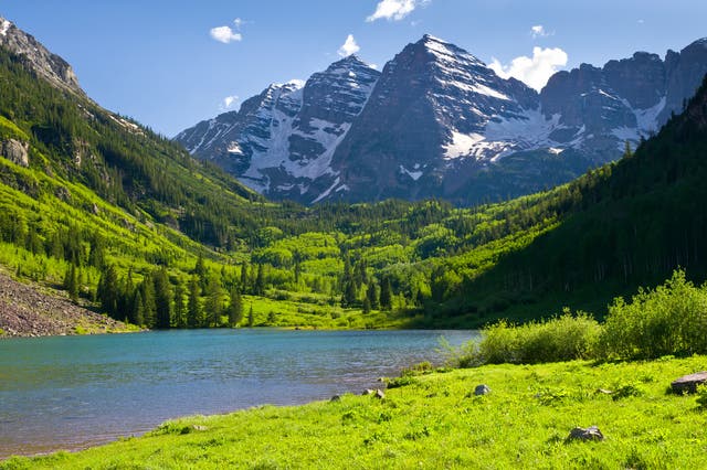 <p>Maroon Bells features several hiking trails and a lake, which a family were seen paddling in despite it being roped off </p>