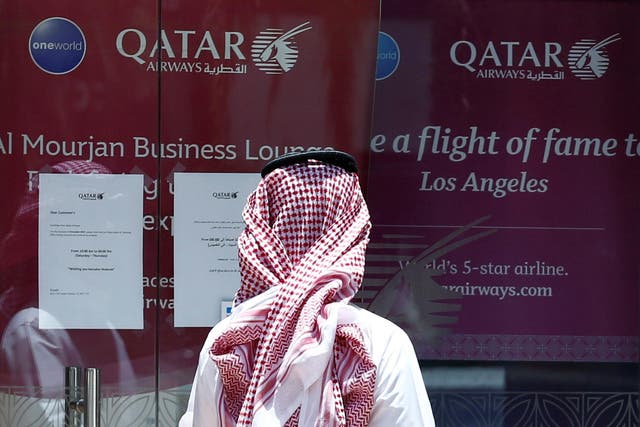 A man stands outside a Qatar Airways office in Riyadh, Saudi Arabia on 5 June 2017
