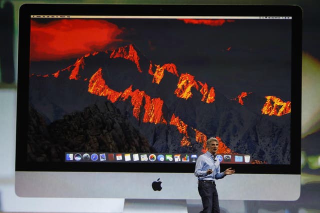 Craig Federighi, Senior Vice President Software Engineering speaks under a projection image of an iMac computer during the company's annual world wide developer conference (WWDC) in San Jose, California, U.S. June 5, 2017