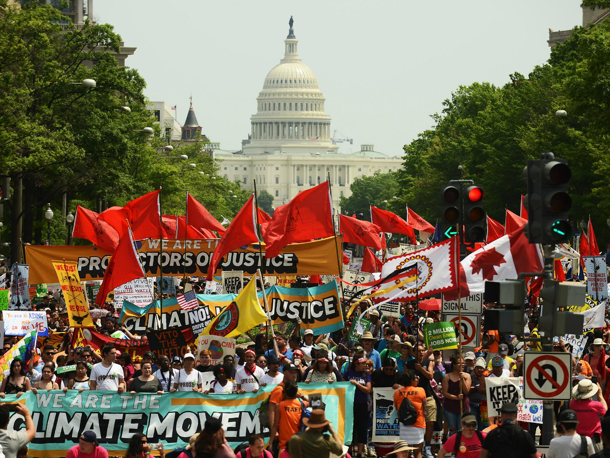 People march from the U.S. Capitol to the White House for the People's Climate Movement to protest President Donald Trump's environmental policies 29 April 2017
