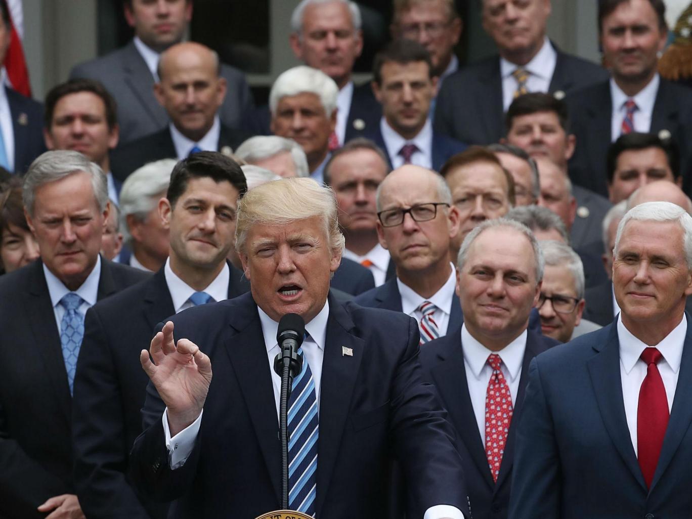 Donald Trump speaks while flanked by House Republicans after they passed legislation aimed at repealing and replacing ObamaCare on May 4, 2017 in Washington, DC
