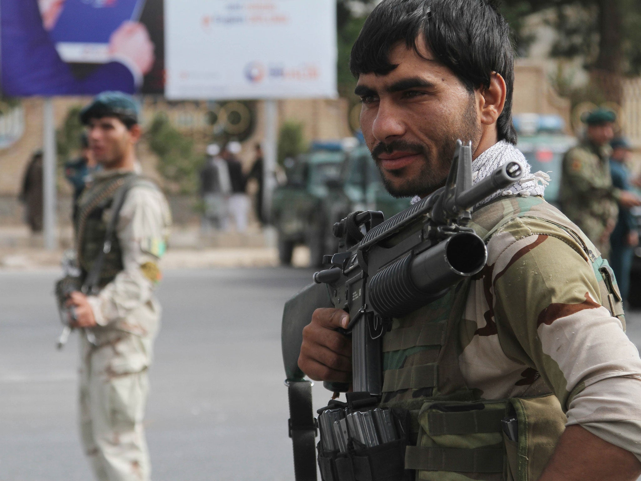 Afghan security officials stand guard at a roadside check as security has been intensified across Herat, following deadly bombings over the weekend in Kabul, in Herat, Afghanistan