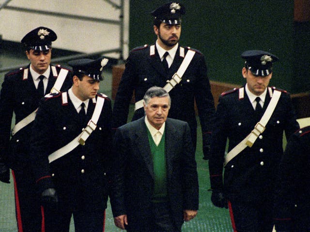 Mafia boss Toto Riina being escorted by Italian Carabinieri officers as he arrives at court in Palermo in 2014