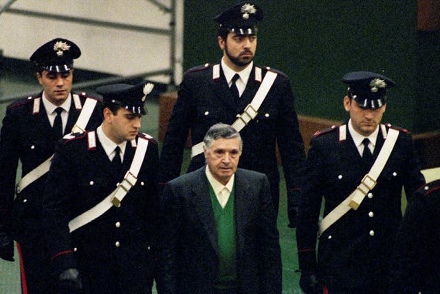 Mafia boss Toto Riina being escorted by Italian Carabinieri officers as he arrives at court in Palermo in 2014