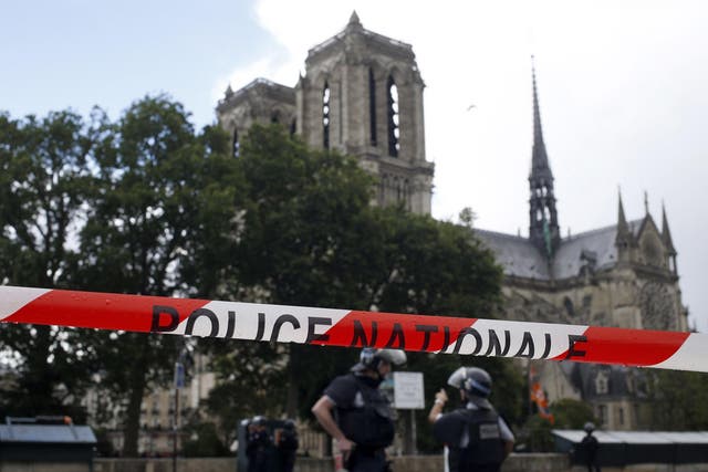 Police officers seal off the access to Notre Dame cathedral in Paris, France, Tuesday, June 6, 2017. Paris police say an unidentified assailant has attacked a police officer near the Notre Dame Cathedral, and the officer then shot and wounded the attacker