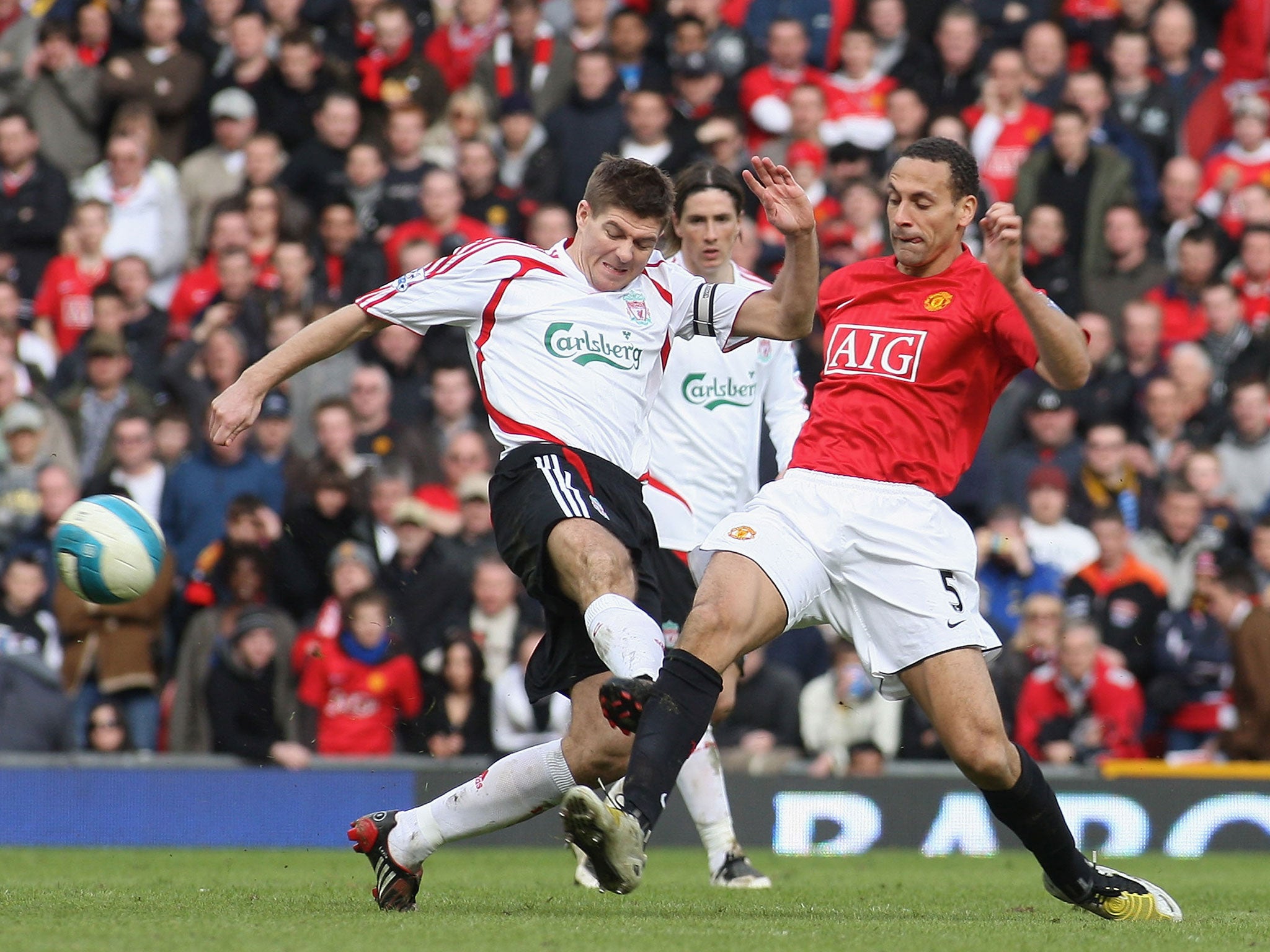 Steven Gerrard puts in a dangerous tackle on Rio Ferdinand during a match between Liverpool and United in 2008