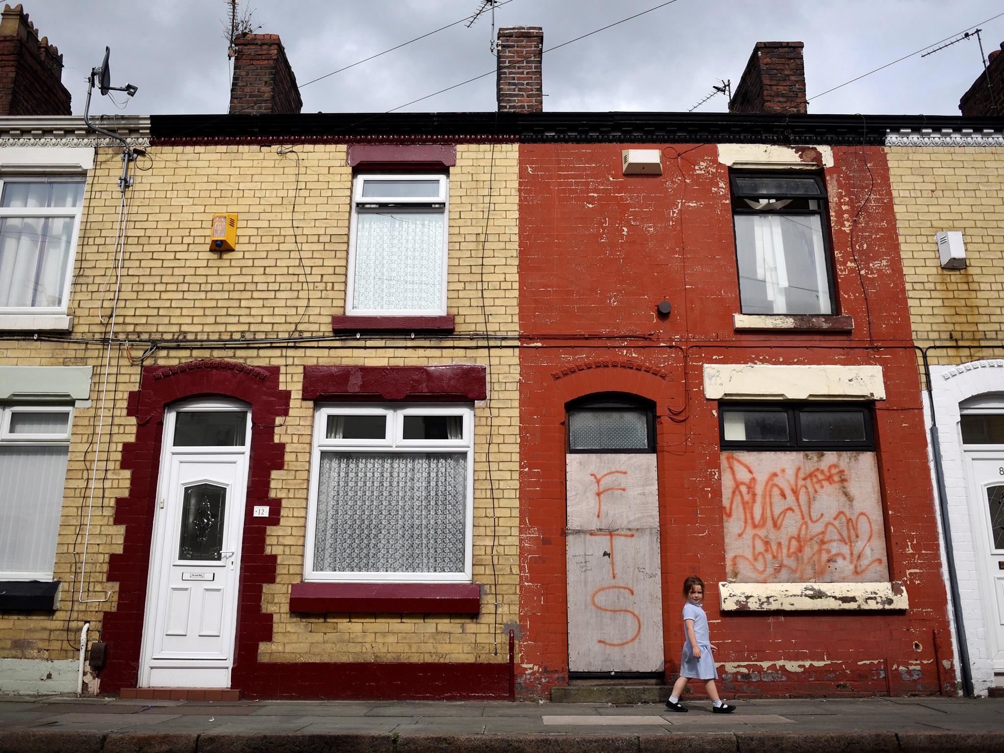 A young girl walks along a residential street in Kensington in Liverpool