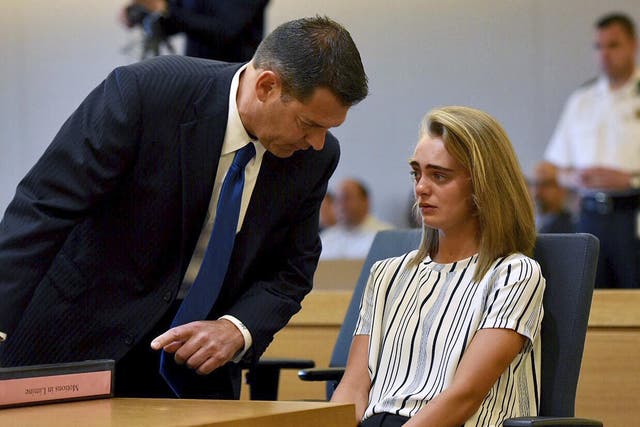 Defence lawyer Joseph Cataldo talks to his client, Michelle Carter, at the beginning of Monday's session at Taunton Juvenile Court in Massachusetts