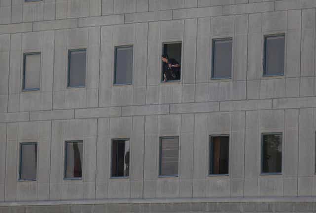 A police officer looks out of the parliament building in central Tehran, Iran, during a terror attack on June 7 2017