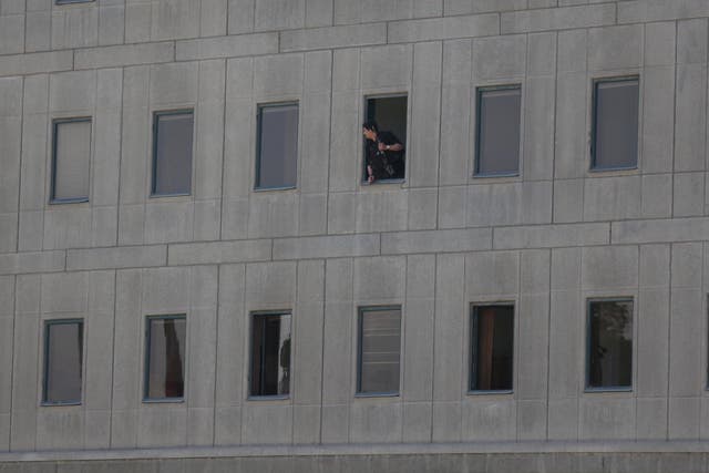 A police officer looks out of the parliament building in central Tehran, Iran, during a terror attack on June 7 2017