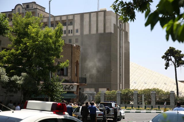 Smoke is seen coming from parliament during a terror attack claimed by Isis in Tehran on 7 June 2017