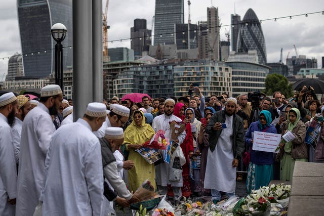 Members of the Muslim community lay flowers after attending a vigil for the victims of the London Bridge terror attacks