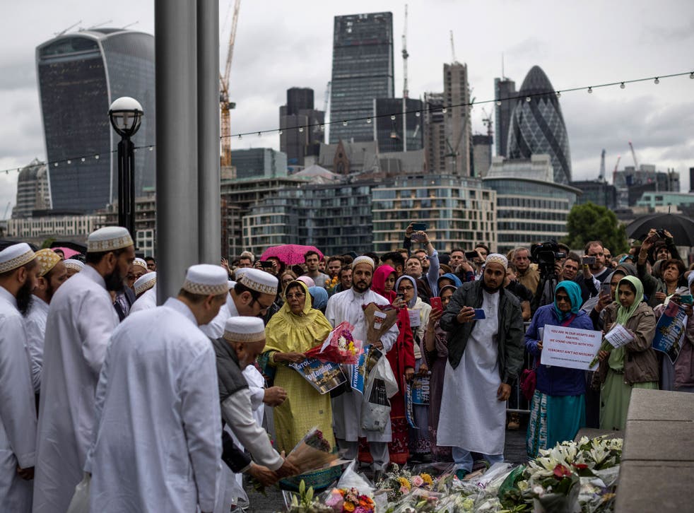 Members of the Muslim community lay flowers after attending a vigil for the victims of the London Bridge terror attacks