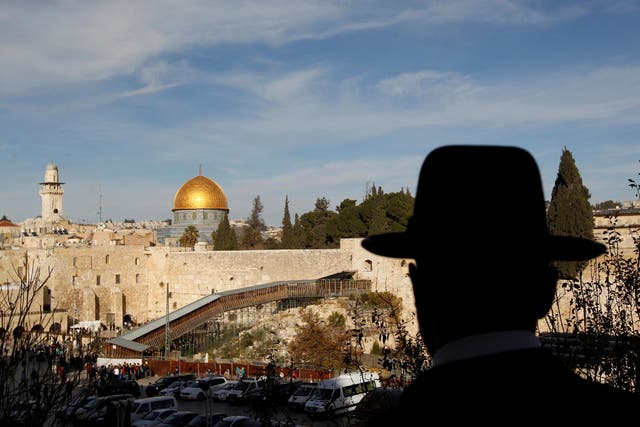 An ultra-Orthodox Jewish man stands at a view-point overlooking a wooden ramp leading up from Judaism's Western Wall to the sacred compound known to Muslims as the Noble Sanctuary and to Jews as Temple Mount, where the al-Aqsa mosque and the Dome of the Rock shrine stand, in Jerusalem's Old City