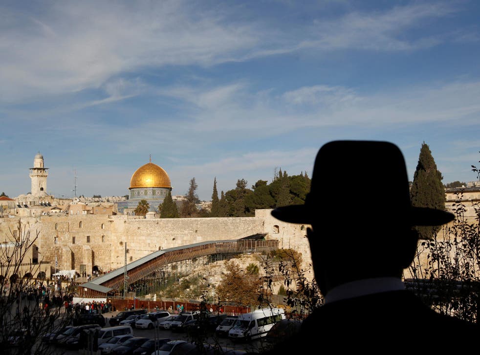 An ultra-Orthodox Jewish man stands at a view-point overlooking a wooden ramp leading up from Judaism's Western Wall to the sacred compound known to Muslims as the Noble Sanctuary and to Jews as Temple Mount, where the al-Aqsa mosque and the Dome of the Rock shrine stand, in Jerusalem's Old City