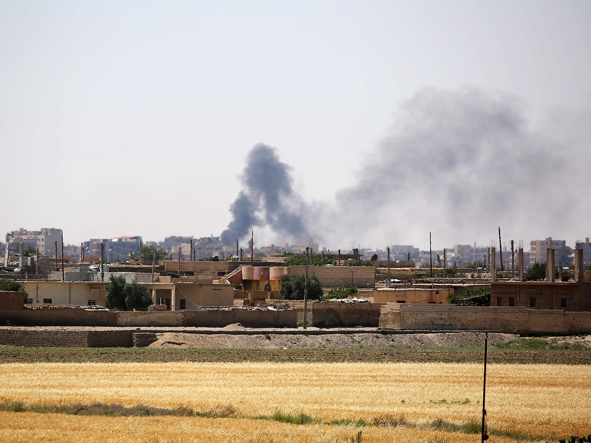 Smoke rises from buildings in the al-Meshleb neighbourhood of Raqa as the Syrian Democratic Forces (SDF), made up of an alliance of Kurdish and Arab fighters, try to advance further into the Islamic State (IS) group's Syrian bastion