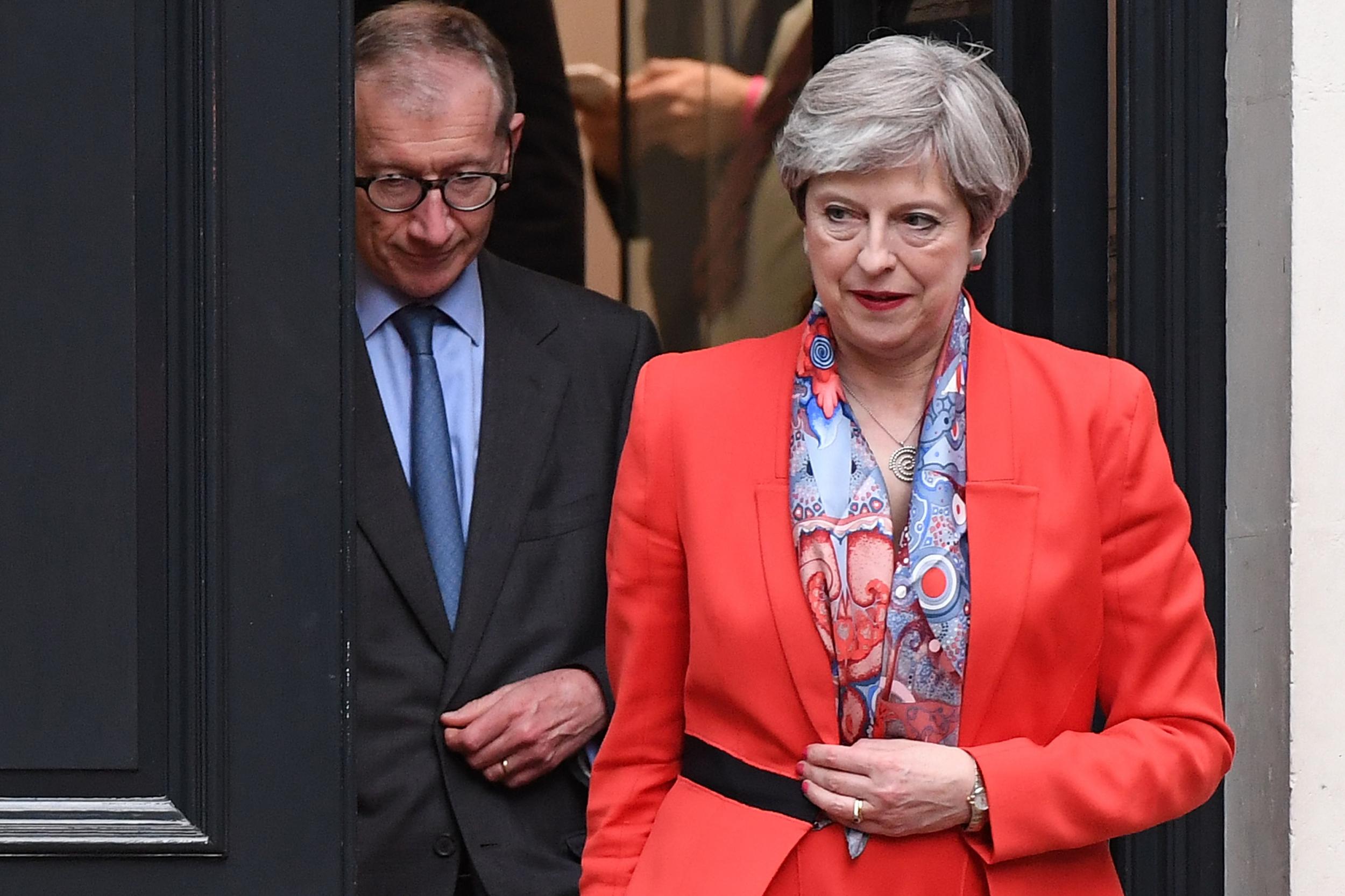 Theresa May leaving Conservative Party HQ with her husband Philip after admitting to activists that it had been a 'difficult' night 